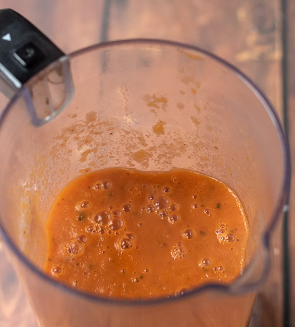 Simple roasted tomato basil soup blended together in a blender jug.